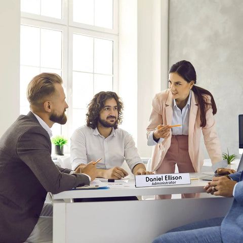 Office meeting with table displaying 20 Pack Acrylic Desk Name Plates 2 By 10 Inch Clear Plastic Name Tent Holders.