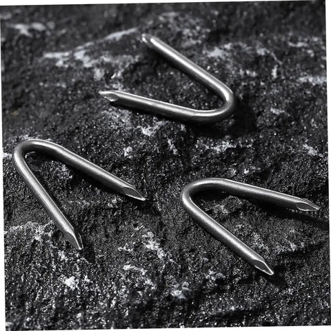 Three U Shaped Garden Stakes And Fixing Nails Set For Fences And Ground Anchors Pro Grade 100 Piece U Nails on rocky surface