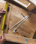 Rock Solid 8 Inch Woodworking Compass And Carbon Steel Scribe Divider With Locking Pin on a workbench with measuring tape.