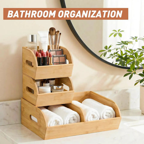 Three tier stackable bamboo organizer with toiletries and rolled towels on marble countertop
