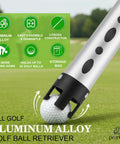 Close-up of Golf Ball Retriever And Picker Upper Tube with aluminum alloy, smart claw grabbing golf ball on grass.
