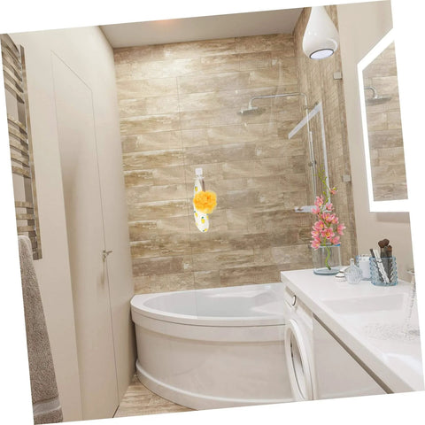 Modern bathroom with corner bathtub, hanging bath sponge, and vibrant flowers on a sleek white countertop.