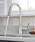 Adler Chrome One Handle Kitchen Faucet With Power Clean Spray And Smooth Reflex High Arc Pull Down Sprayer flowing water in modern kitchen