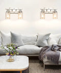 Living room with two Modern Two Light Vanity Light Fixtures In Brushed Nickel With Clear Glass Shades above a sofa, enhancing decor.