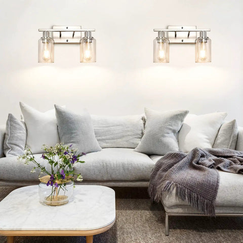 Living room with two Modern Two Light Vanity Light Fixtures In Brushed Nickel With Clear Glass Shades above a sofa, enhancing decor.