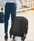 Front view of black rolling backpack with extendable handle and four wheels; airline‑approved underseat luggage with visible brand logo.