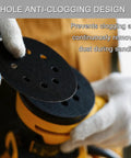 Close-up of 100 Pcs 5 Inch Sanding Discs Hook And Loop With 8 Holes Wet Dry Sandpaper on orbital sander in use