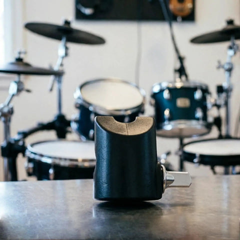 Heavy Duty Electronic Drum Cymbal Rotation Stopper displayed on table, sturdy metal clamp for secure positioning in a drum setup.