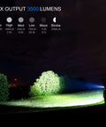 Night scene with Beast Mode 3500 Lumen USB C Rechargeable Flashlight illuminating trees, showing beam modes and range up to 1000 feet.