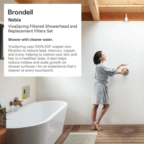 Woman adjusting filtered shower head with chrome slate face and wide rain spray for softer skin and hair, in stylish bathroom.
