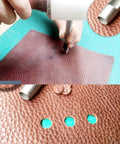 Using 10 Pack Leather Hole Punch Set 0.5mm To 3.5mm on leather for precise holes; carbon steel tool in action on leather crafting project.