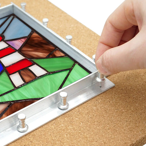 Professional Stained Glass Layout Block System With 80 Push Pins holding stained glass panel square with aluminum frame.