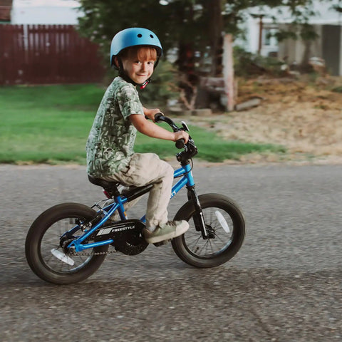 Child riding a blue 16 inch kids bike for ages 4 and up, BMX style youth bicycle with training wheels, coaster brake and rear V brake