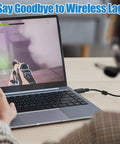 Gamer using laptop connected via cable for reduced lag during gameplay