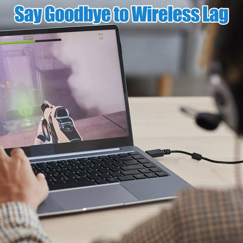 Gamer using laptop connected via cable for reduced lag during gameplay