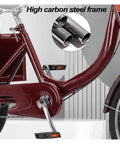 Close-up of adult tricycle rickshaw frame showing high carbon steel structure with pedals and partial chain drive.