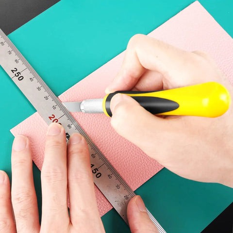 Person using Ultimate 16 Piece Exacto Knife Set With Magnetic Storage Case for crafting, cutting pink foam with precision knife and ruler.