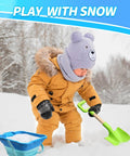 Child playing in snow with green 16 Inch Beach Sand Shovel Toy For Kids, Jumbo Garden Scoop Tool Kit; snow bucket nearby.