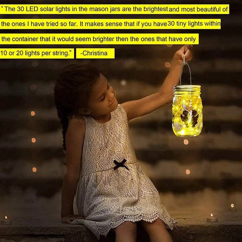 Child holding glowing jar with Solar Mason Jar Lid Lights With 30 Warm White LEDs, Waterproof Outdoor Fairy String Lights, night scene.