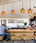 Total Vibe Hand Woven Rattan Pendant Light above a modern bar setting, showcasing airy Boho chandelier style.