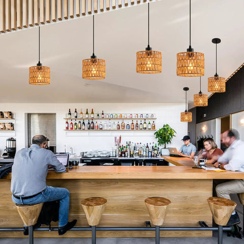 Total Vibe Hand Woven Rattan Pendant Light above a modern bar setting, showcasing airy Boho chandelier style.