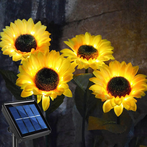 Upgraded 4 Flower Solar Sunflowers With Fairy Light Petals For Yard Decor, glowing in garden with solar panel base.
