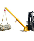 Heavy Hitter Telescoping Forklift Jib Boom Crane Attachment lifting steel pipes with adjustable tilt and 6600 lb capacity.