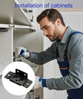Man installing cabinet with Heavy Duty Stainless Steel Corner Brackets For Wood Furniture L Shape Joint Braces Black Set Of 16 Built Tough