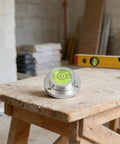 Small Horizontal Bubble Level on a wooden workbench, with high sensitivity vial and metal flange design.