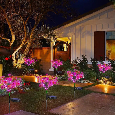 Outdoor Solar Flower Lights Set Phalaenopsis Orchid Solar Garden Lights Waterproof IP65 2 Pack illuminating a patio garden at night