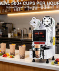Hella Efficient Full Auto Cup Sealer Machine With Smooth Operator Boba And Coffee Sealing Tech Featuring Top Shelf Digital Screen Control and No Sweat Leak Proof Heat Lock In Classic White Finish For Quick Cafe Shifts sealing cups on a countertop.