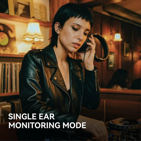 DJ using wired over-ear studio monitoring headphones with 50mm drivers for mixing and recording in a cozy studio setting