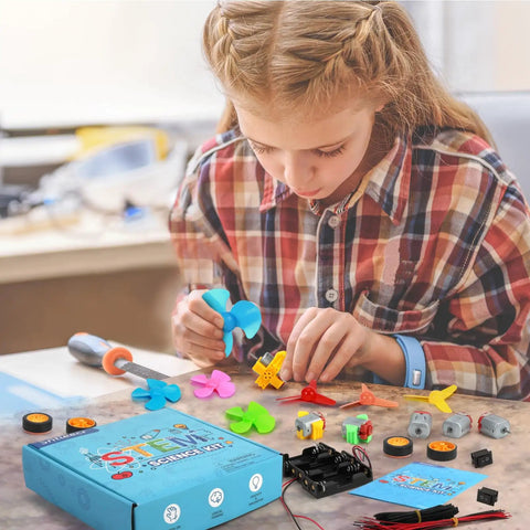 Child assembling 276 Piece DC Motor Kit For DIY Science Projects with motors, LED lights, vanes, and propellers on a table.