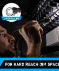 Man using Telescoping Magnet Pickup Tool With 3 LED Magnetic Flashlight in dim space, highlighting hard-to-reach areas.