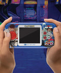 Hands holding Street Fighter II Pocket Player Pro Handheld Console 2 In 1 Capcom Licensed Classics For Retro Gaming Fans