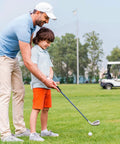 Adult teaching child to swing on golf course with a focus on Three Pack Golf Grip Trainer Set For Right Handed Golfers Easy Swing Trainer Accessories To Boost Your Grip Build Muscle Memory And Correct Hand Position For Consistent Controlled Swings.