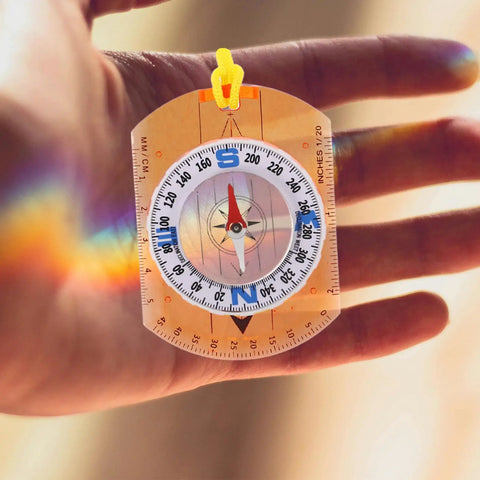Orange Survival Compass With Lanyard The Do It All Hiking Navigator Tool in hand showing details and ruler feature