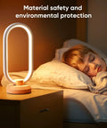 Modern Ellipse LED Desk Lamp With Wood Accent beside sleeping child, dimmable warm white night light for bedroom and nightstand.