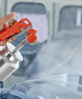 Handheld Slick Pneumatic Paint Sprayer Set For Car Body and Interior, spraying smooth paint finish on a car surface.
