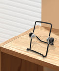 Two Pack Foldable Solar Panel Stands With Adjustable Tilt Mounts, durable black metal support on wooden surface
