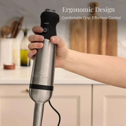 Heavy Duty Stainless Steel Immersion Blender With Kickass 600 Watt Motor And Turbo Switch held in hand showing ergonomic design.