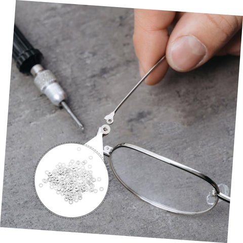 Eyeglass Frame Gaskets And Metal Flat Washers Must Have Kit With 200 Pcs Replacement Screws For Rimless Glasses Quick Repair And Durable Maintenance For Long Lasting Eyewear Life. Close-up of repair using gaskets and screws on rimless glasses.