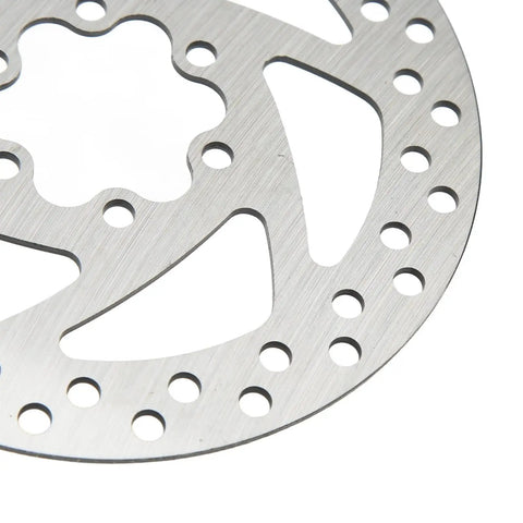 Close-up of 140mm stainless disc brake rotor with 6 bolt mount for bikes and electric scooters; anti wear and corrosion resistant design.