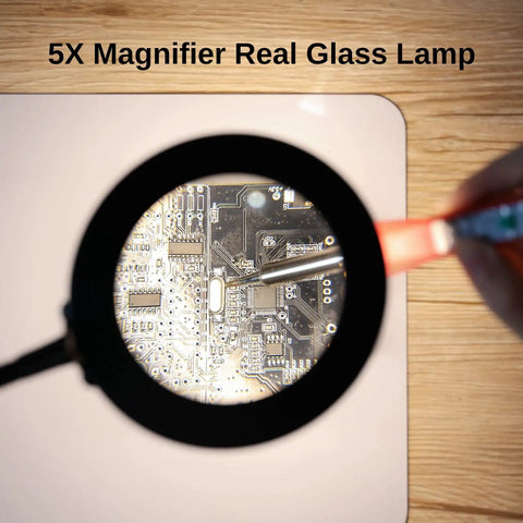 Close-up of 2 In 1 Magnetic Helping Hands Soldering Station with 5X LED magnifying lamp focusing on PCB details on silicone mat.
