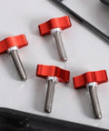 4 Pack 1/4 20 X 1 Inch Stainless Steel Thumb Screws Hella Durable Finger Bolts arranged on surface, showing red knobs and threads.