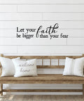 Wood bench with pillows in front of wall featuring 'Let your faith be bigger than your fear' vinyl decal.