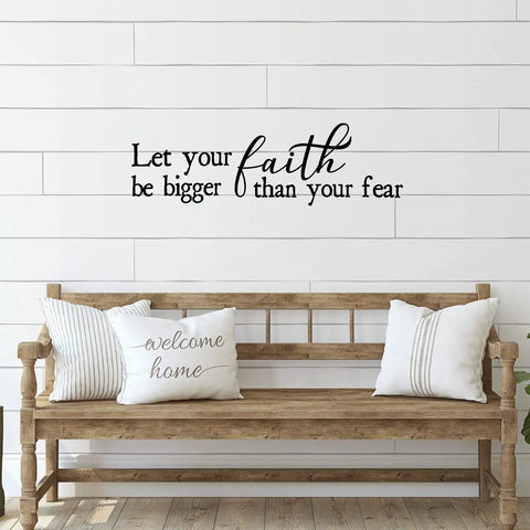 Wood bench with pillows in front of wall featuring 'Let your faith be bigger than your fear' vinyl decal.