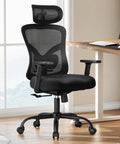Ergonomic Office Chair With Lumbar Support And 2D Headrest Adjustable Armrests Contoured Seat Cushion Swivel Desk Chair On Wheels For Home Office And Gaming Built For All Day Comfort in black, beside a desk in a home office setting.