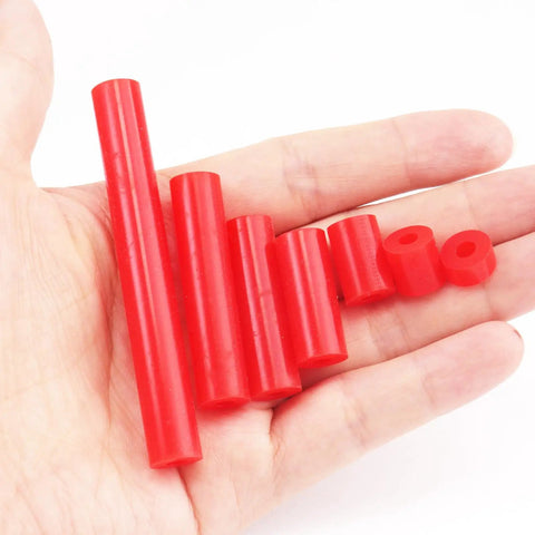 Heavy Duty Outlet Spacers And Screw Mount Kit Featuring Top Shelf Silicone And Corrosion Resistant Steel Build For A Quick Six Thirty Two Thread Fit That Makes Rough Electrical Jobs Sweet And Simple, red silicone spacers displayed in hand.