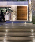 12 Pack 1W COB LED Low Voltage Landscape Ground Lights illuminate stone steps and tree at night, outdoor well lights.